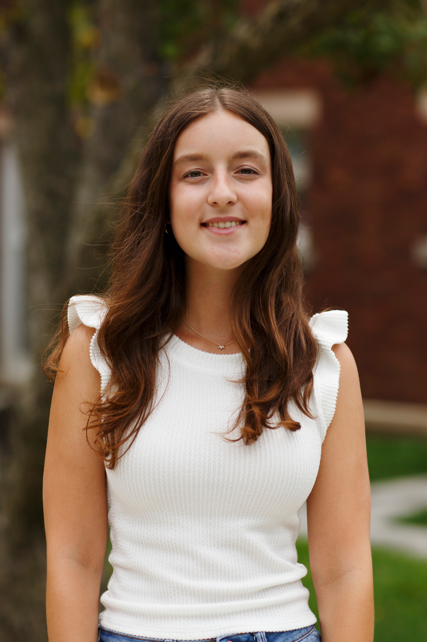 Woman with brown hair and a white shirt