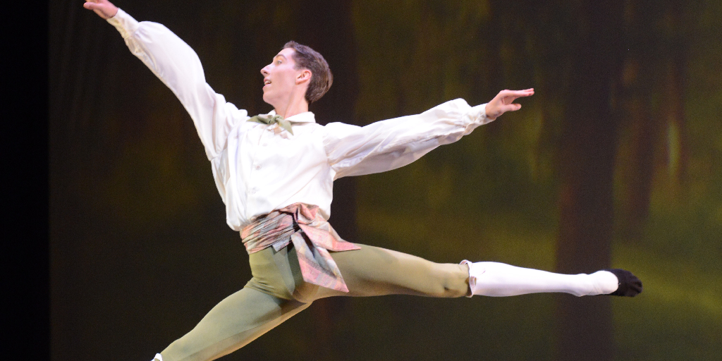 Male ballet dancer mid-jump