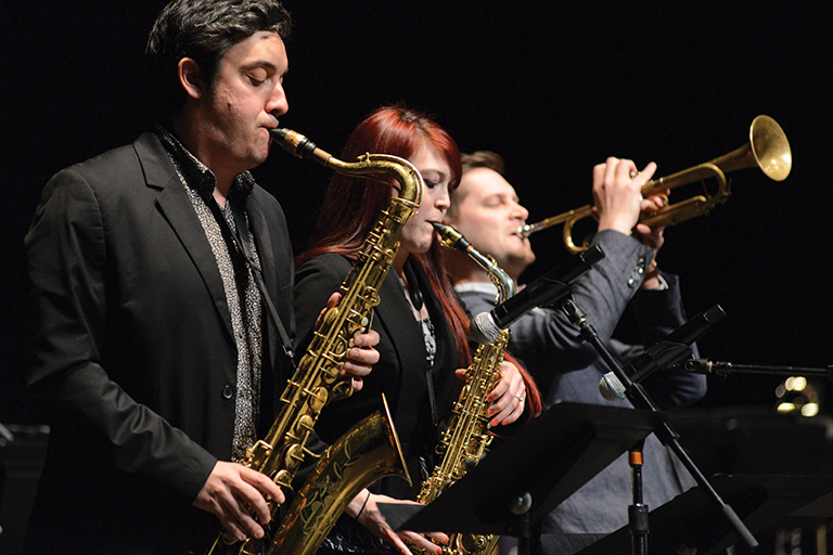 Image from IU Jacobs Jazz concert featuring two students and John Raymond performing a trio.